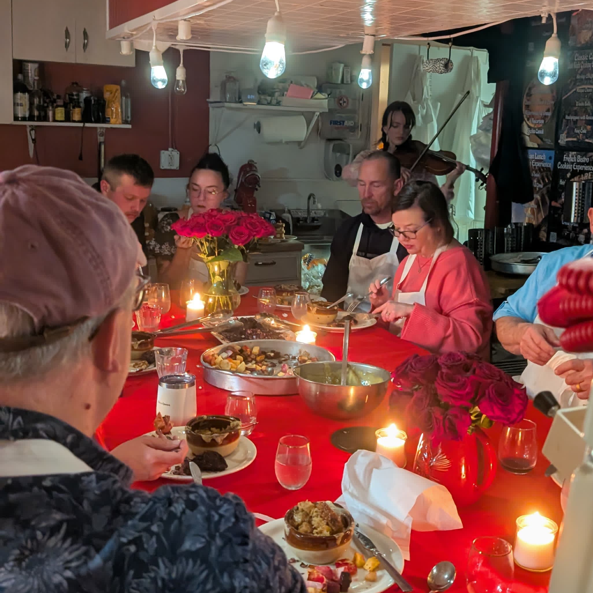 guests enjoying a premium valentine's day cooking experience with live violin music