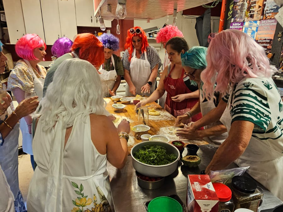 Katie Kring cooking with guests during a private Pickwick & Cherry class celebrating a bachelorette party